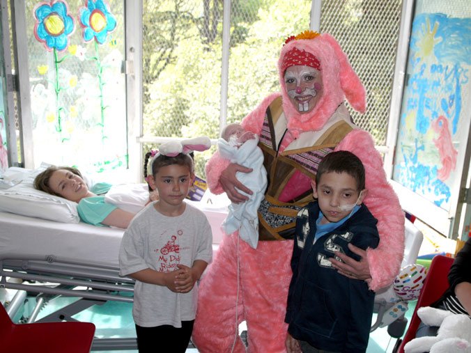 children in hospital ward with easter biker bunny!
