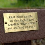 A poem on a plaque on a bench